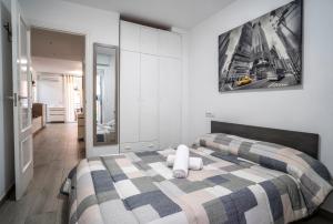 a bedroom with a bed with a checkered blanket at Apartamento Ponent Stays in Almacellas