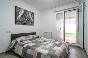 a bedroom with a bed with a picture on the wall at Apartamento Ponent Stays in Almacellas +9 photos