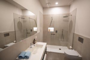 a bathroom with a shower and a toilet and a sink at Al Ventisei - Azzurro in Treiso +15 photos