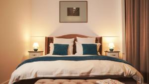 a bedroom with a large bed with two lamps at Weiss Central Boutique in Braşov