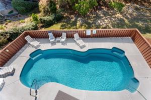an overhead view of a swimming pool with chairs and a swimming pool at 2058 - Blessed by the Sea Duck in Duck