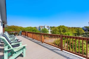 a row of benches sitting on a deck at 2058 - Blessed by the Sea Duck in Duck