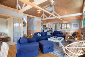 a living room with blue couches and a table at 2058 - Blessed by the Sea Duck in Duck +56 photos