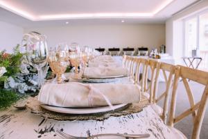 a long table with wine glasses and plates on it at Hotel Villa Florida Veracruz in Veracruz +26 photos
