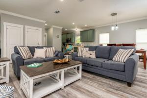 a living room with two couches and a table at Blue Haven - 1414 Oleander in Dauphin Island