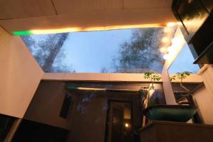 a room with a window and a green chair at Vintage Lovers` Cabin with Jacuzzi & Lake Access in Linden +36 photos