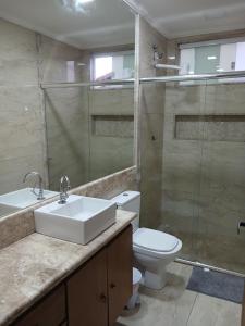 a bathroom with a sink and a toilet and a shower at Pousada Litorânea in Saquarema +102 photos