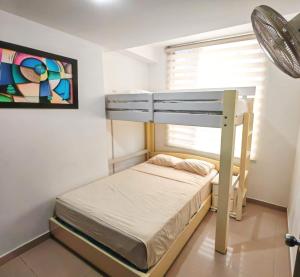 a bunk bed in a small room with a window at ARENA PLAZA DEPARTAMENTO PLAYA con vista al mar in Tonsupa +21 photos