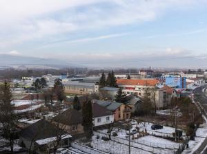 a city with snow covered roofs and buildings at Apartmán Mlynská in Vranov nad Topľou