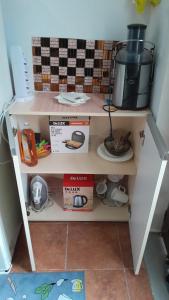 a shelf in a kitchen with a coffee maker on it at Tonia&Sion in Vlorë