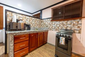 a kitchen with a stove and a microwave at San Gabriel Apartments in Fortuna