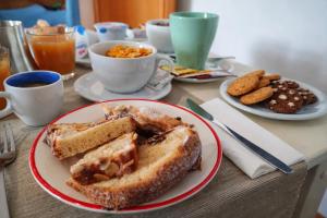 a table with a plate of food with a sandwich at B&B il Faso vicino Zoosafari di Fasano in Fasano