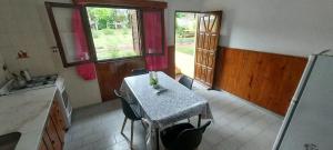 a kitchen with a table in the middle of a room at ARROYO SERRANO-MINA CLAVERO in Mina Clavero +26 photos