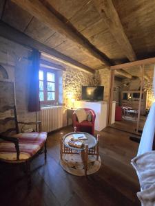 a living room with a couch and a table at chez Karine in Ceyzérieu +27 photos