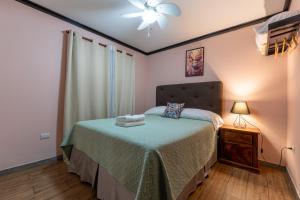 a bedroom with a bed and a ceiling fan at San Gabriel Apartments in Fortuna +32 photos