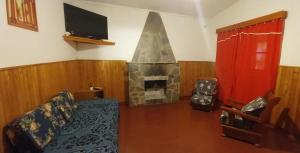 a living room with a couch and a fireplace at ARROYO SERRANO-MINA CLAVERO in Mina Clavero