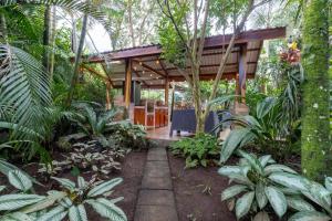 a garden with a pavilion with plants and trees at San Gabriel Apartments in Fortuna
