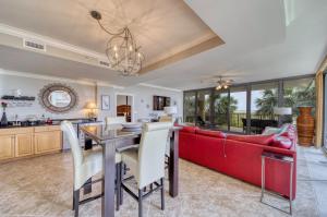 a living room with a red couch and a table at Holiday Isle 122 in Dauphin Island