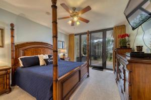 a bedroom with a bed and a ceiling fan at Holiday Isle 122 in Dauphin Island