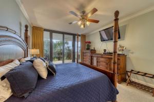 a bedroom with a bed and a ceiling fan at Holiday Isle 122 in Dauphin Island +21 photos