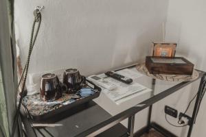 a table with two tea cups and a box on it at Golden house in Cefalù