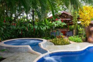 a pool in the middle of a garden at San Gabriel Apartments in Fortuna