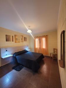 a bedroom with a black bed in a room at Balcones de Bialet in Bialet Massé