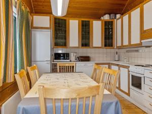 a kitchen with a table and chairs in it at Holiday Home Sallassi by Interhome in Salla +10 photos
