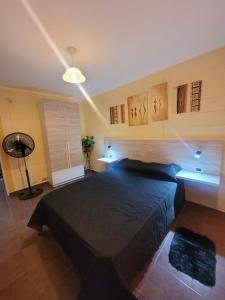a bedroom with a large bed in a room at Balcones de Bialet in Bialet Massé +25 photos