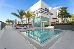a swimming pool in front of a house at 1Bd Top Location Downtown Miami in Miami