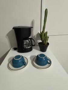 a counter top with two blue cups and a coffee maker at Chalé da Ana in Tutóia +17 photos