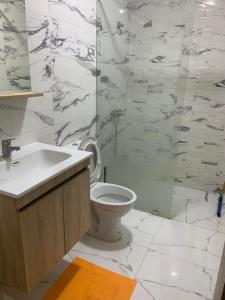 a white bathroom with a toilet and a sink at Studio dream place in Kenitra