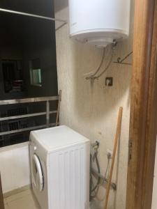 a white washer and dryer in a bathroom at Studio dream place in Kenitra