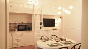a dining room with a table and a bunk bed at Weiss Central Boutique in Braşov