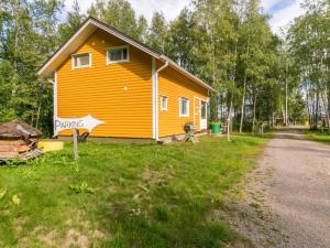 a yellow house on the side of a road at Holiday Home Pöllö by Interhome in Verla