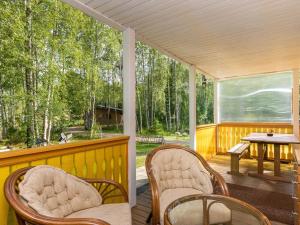 a screened in porch with chairs and a table at Holiday Home Pöllö by Interhome in Verla