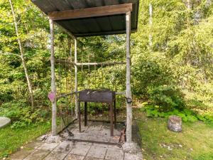 an out house with a gate in the grass at Holiday Home Pöllö by Interhome in Verla