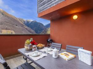 a table with food and a view of mountains at Apartment Casa del Bitto by Interhome in Pedesina