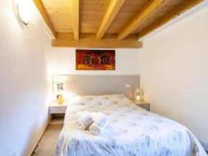 a bedroom with a bed with towels on it at Apartment Casa del Bitto by Interhome in Pedesina