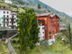 a group of buildings on a hill with a tree at Apartment Casa del Bitto by Interhome in Pedesina