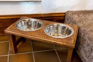 two metal bowls sitting on top of a wooden table at Hoot Cottage in Oakworth +14 photos