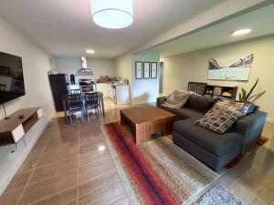 a living room with a couch and a table at Coastal Drift Sooke in Sooke