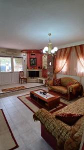 a living room with a couch and a table at Giorgos-Vera in Kavála