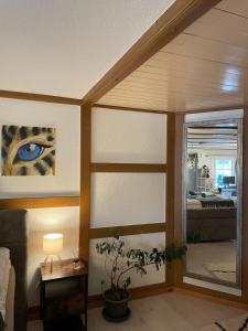 a living room with a window and a room with a bed at Studio with Kitchen & Parking near Thun and Bern in Herbligen  +11 photos