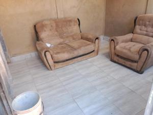 two chairs and a chair in a room at Rest Easy in Grasmere