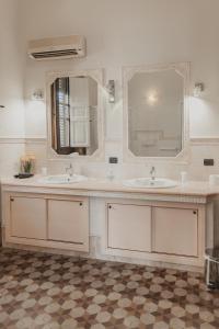 a bathroom with two sinks and a mirror at Golden house in Cefalù +141 photos