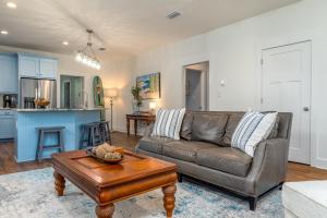 a living room with a couch and a table at Lavender Haze - 1209 Chaumont in Dauphin Island