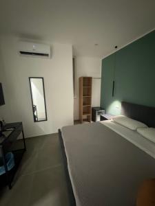 a bedroom with a large bed and a mirror at Luxury Rooms Soraja in Palermo