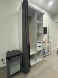 a white closet with a black curtain in a room at Luxury Rooms Soraja in Palermo