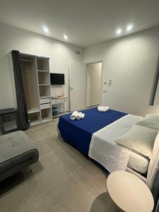 a large bedroom with a large bed and a couch at Luxury Rooms Soraja in Palermo
